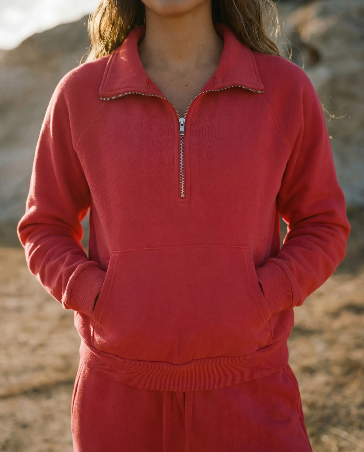 Sundry Berry half zip sweatshirt displayed on a hanger, showcasing its soft fabric and stylish design.