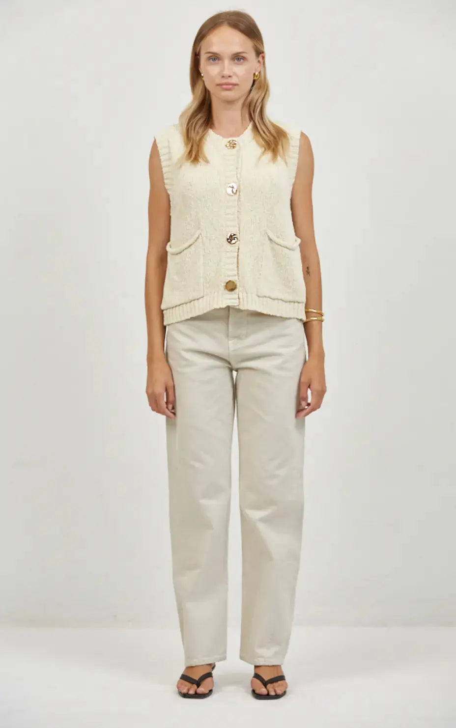 A.ren Marais buttoned knit vest in extra small, featuring a cozy knit fabric with button details, worn layered over a shirt.