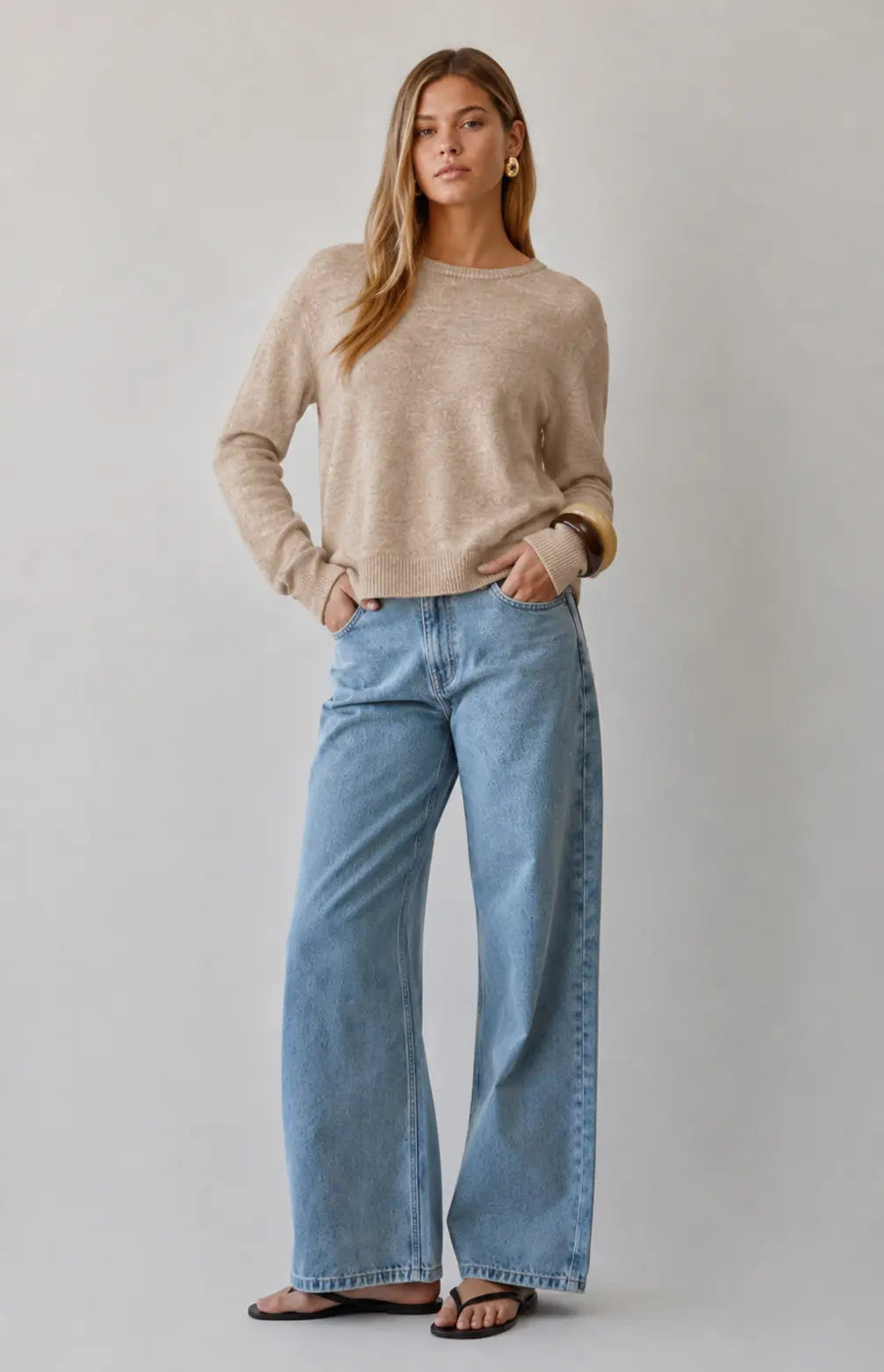 A.ren The Haven beige knit sweater displayed flat, showing its cozy, textured fabric and classic round neckline.