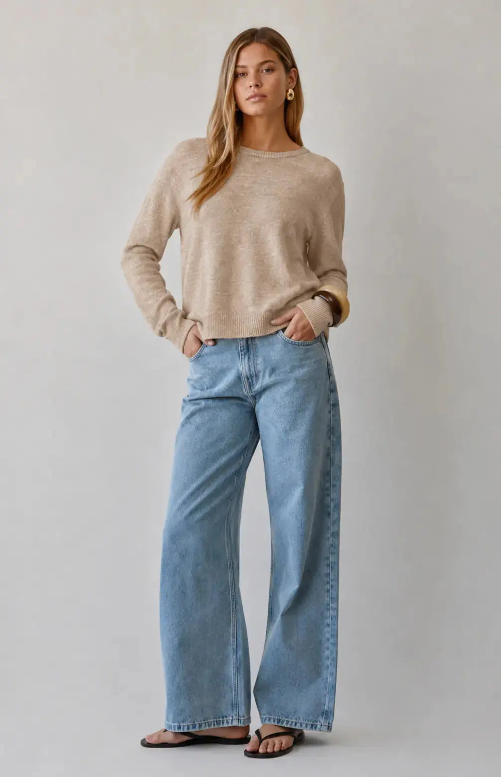 A.ren The Haven beige knit sweater displayed flat, showing its cozy, textured fabric and classic round neckline.