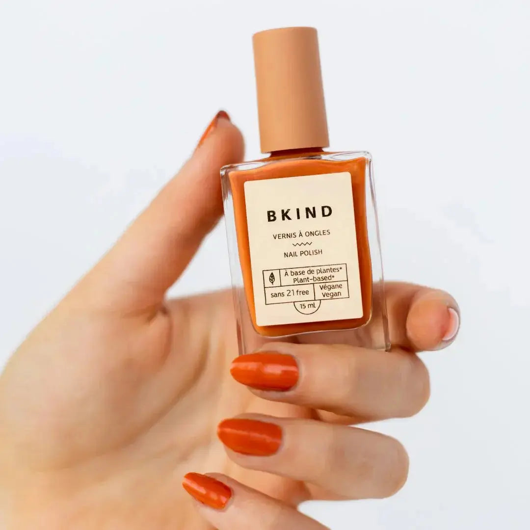 BKIND Lovefool nail polish bottle with vibrant pink polish inside and the brand label visible.