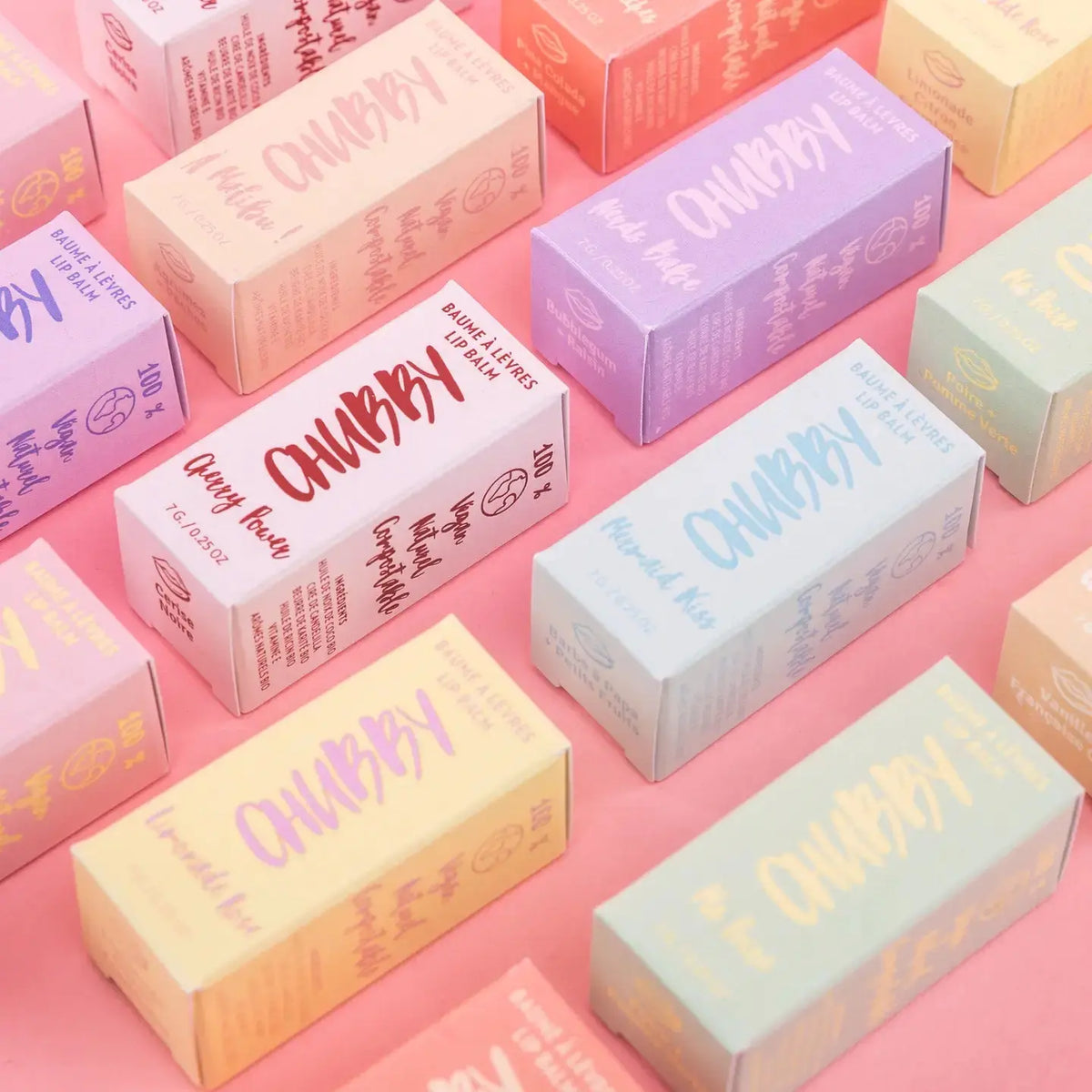 Caprice & Co Chubby vegan lip balm with tropical flavors like Aloha Beaches, Pina Colada, and Mango, in colorful packaging.