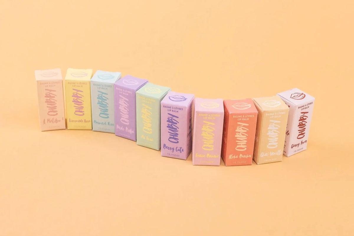 Caprice & Co Chubby Vegan Lip Balm featuring tropical flavors like Aloha Beaches, Pina Colada, and Mango in colorful packaging.