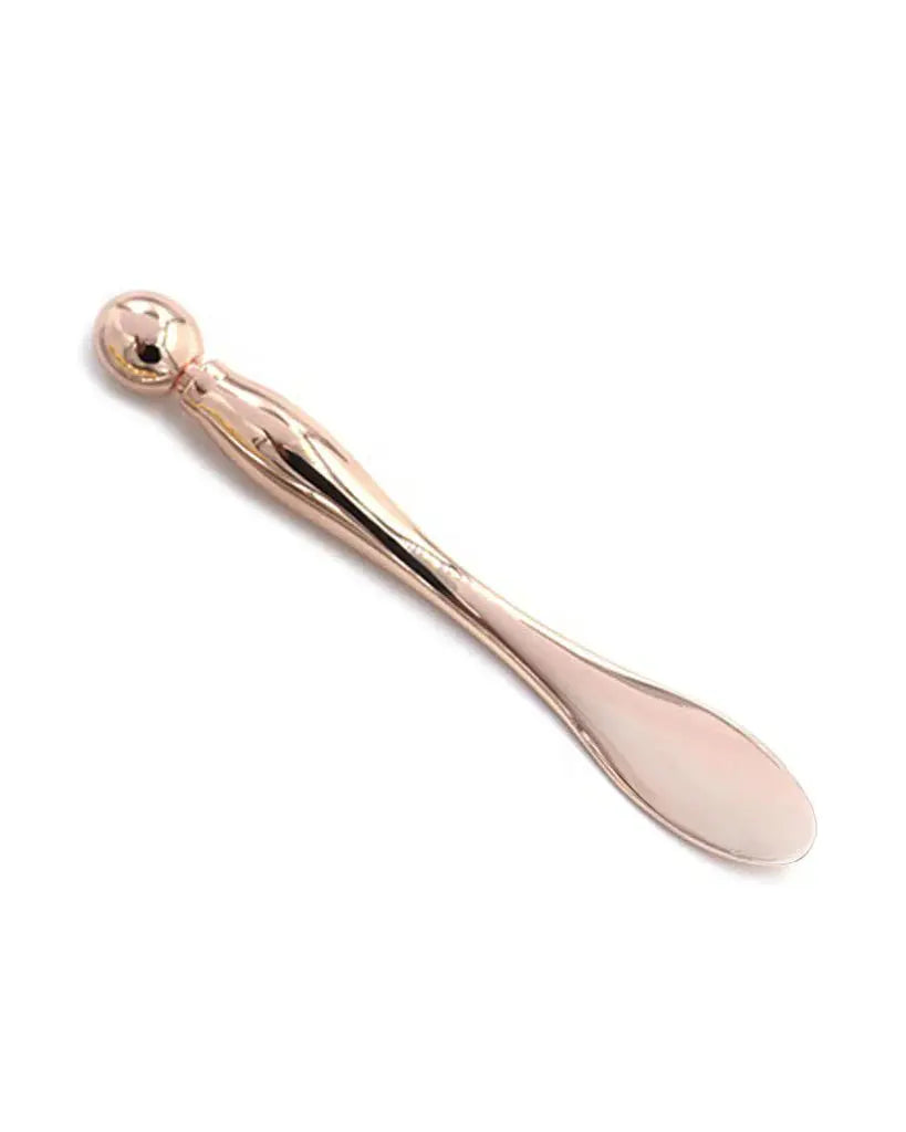 Rose gold applicator and acupressure multi-tool by Earth Harbor, featuring sleek design and versatile skincare massage tools.
