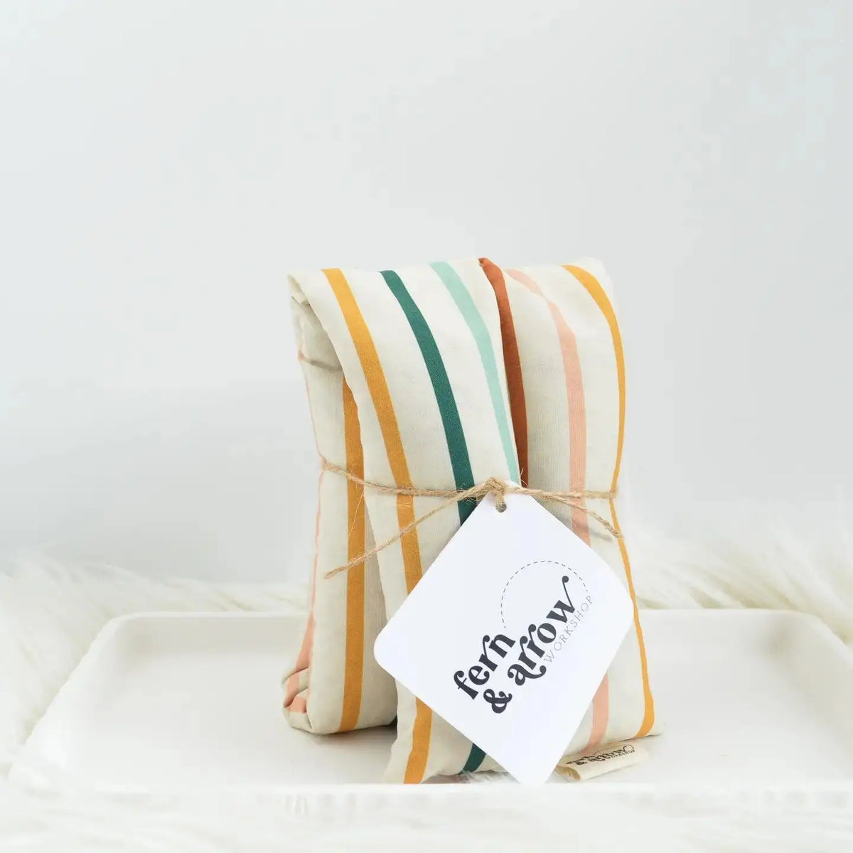 Fern and Arrow Aroma Therapy Neck Wrap in Juliette Stripe, a soft personal wrap for relaxing aromatherapy experiences.