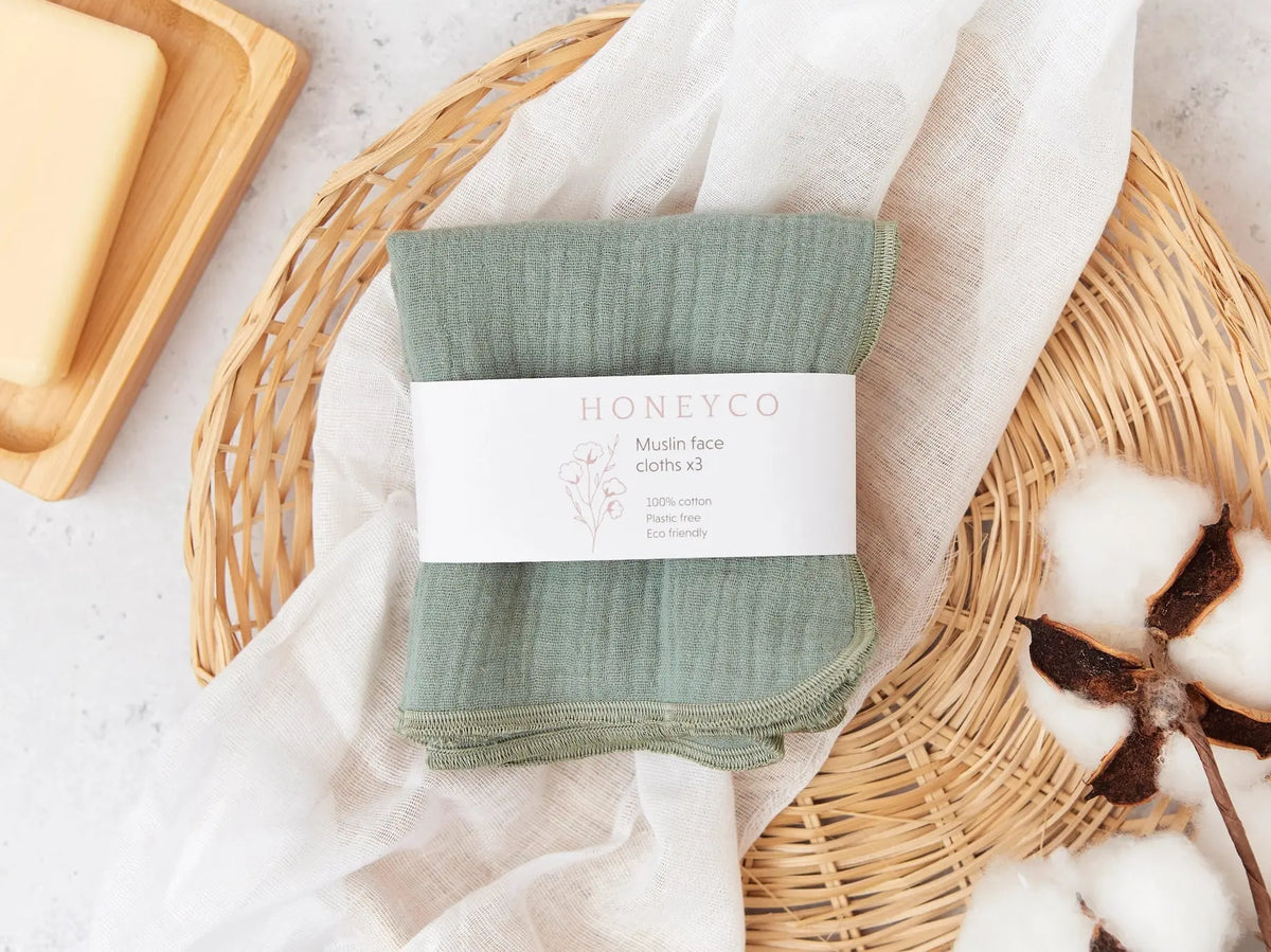 Set of green HoneyCo muslin reusable face cloths, soft and breathable for gentle facial cleansing.