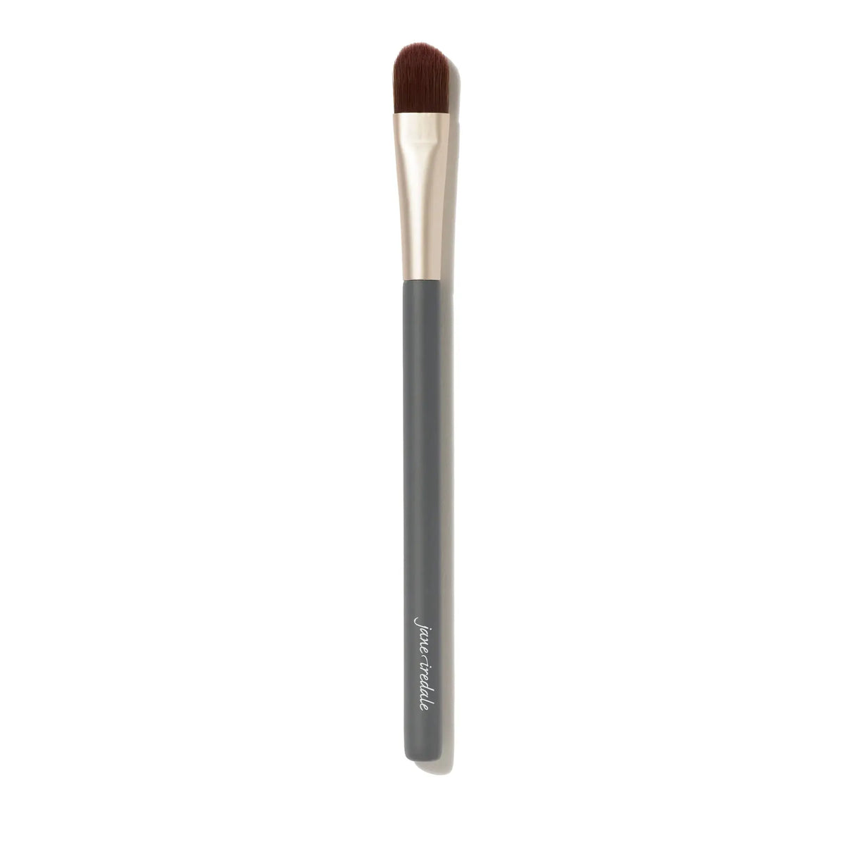 Jane Iredale camouflage brush with a rounded handle and dense bristles for precise makeup application and blending.