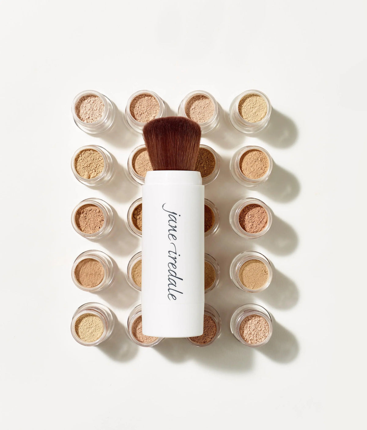 Jane Iredale Powder-Me SPF 30 dry sunscreen in translucent powder form, providing sun protection with a lightweight, talc-free formula.