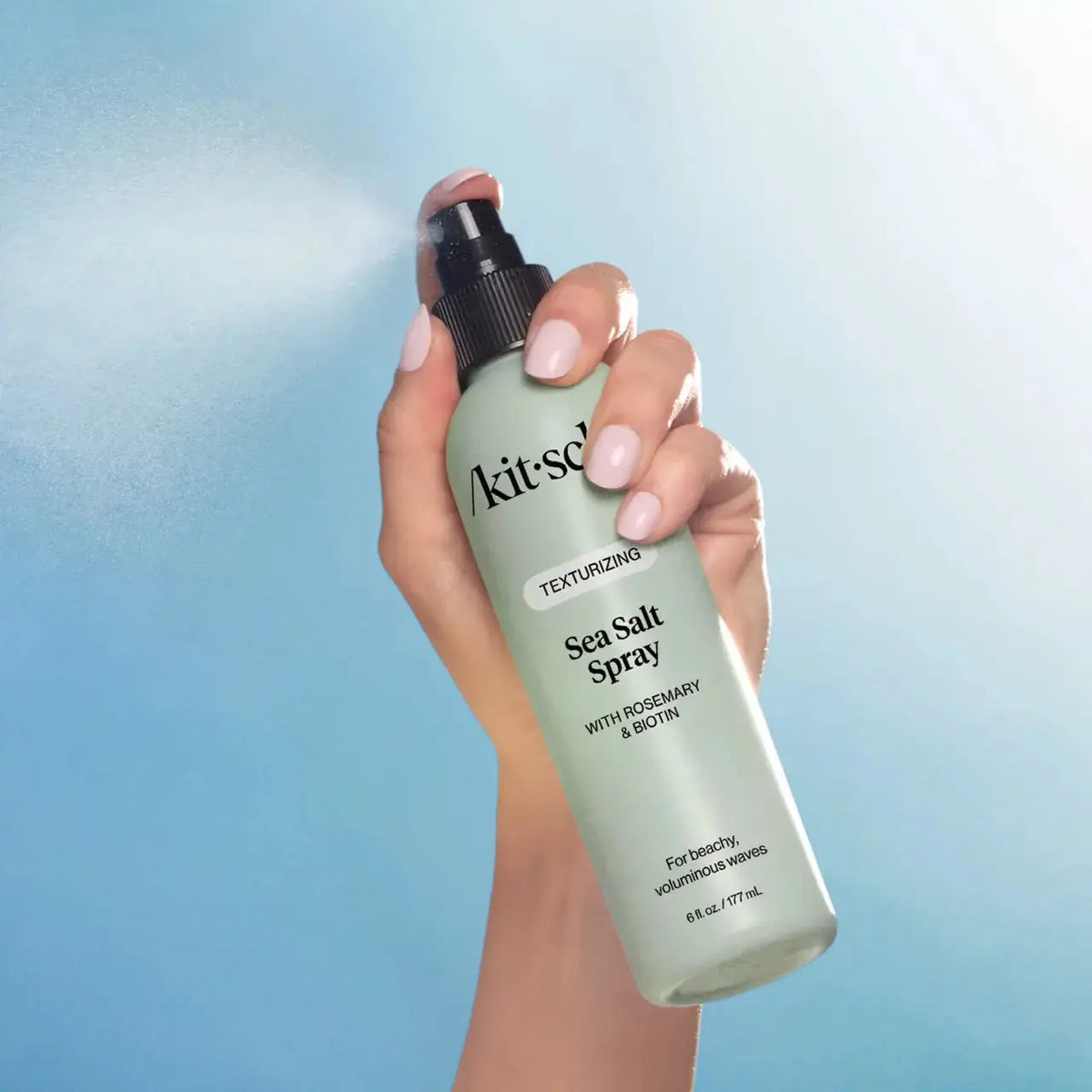 Kitsch Texturizing Sea Salt Spray for hair care, showing the spray bottle with sea salt formula and hair styling in the background.