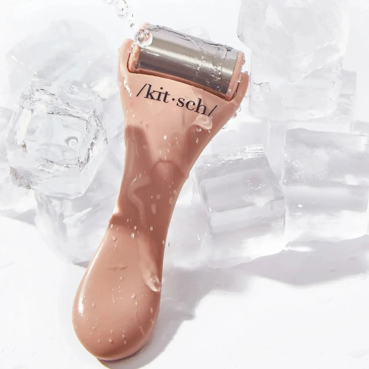 Kitsch Cool Down Ice Roller for skincare, featuring a clear handle and metal roller ball for soothing facial cooling therapy.
