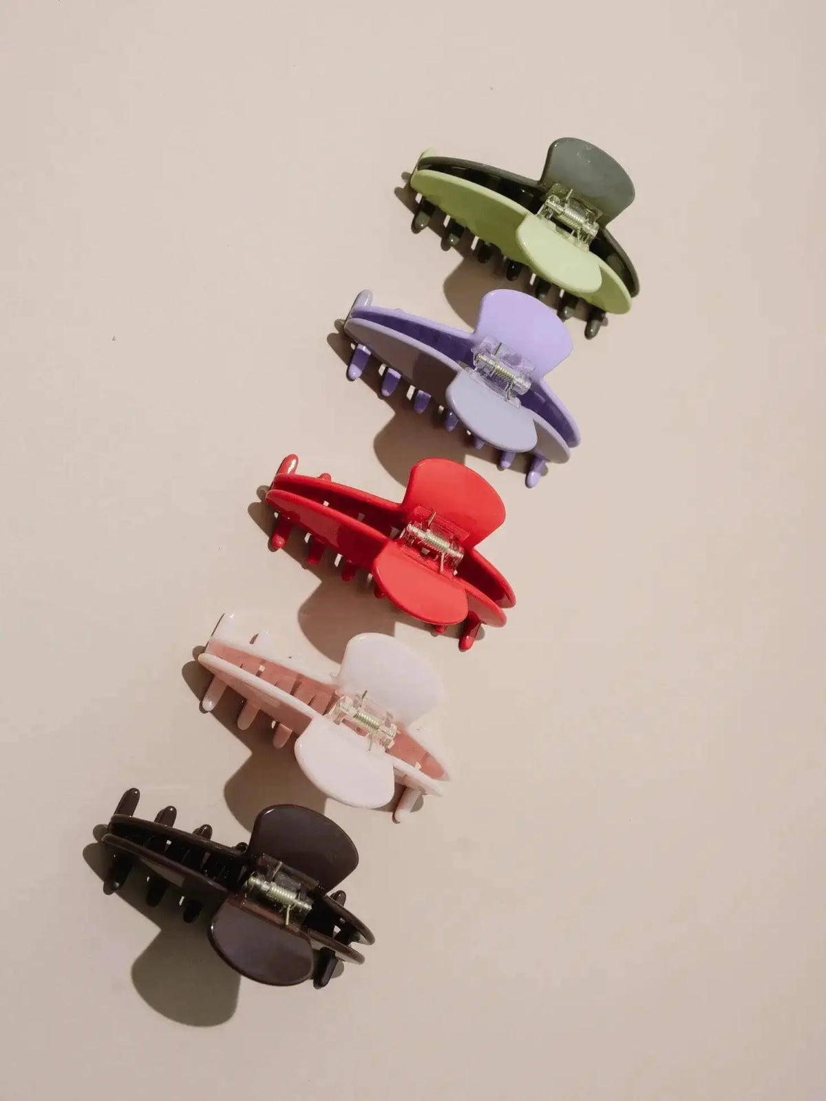 Nat + Noor Jaycee Hair Claw in blush, a stylish hair accessory with a sleek design for securing hair comfortably.