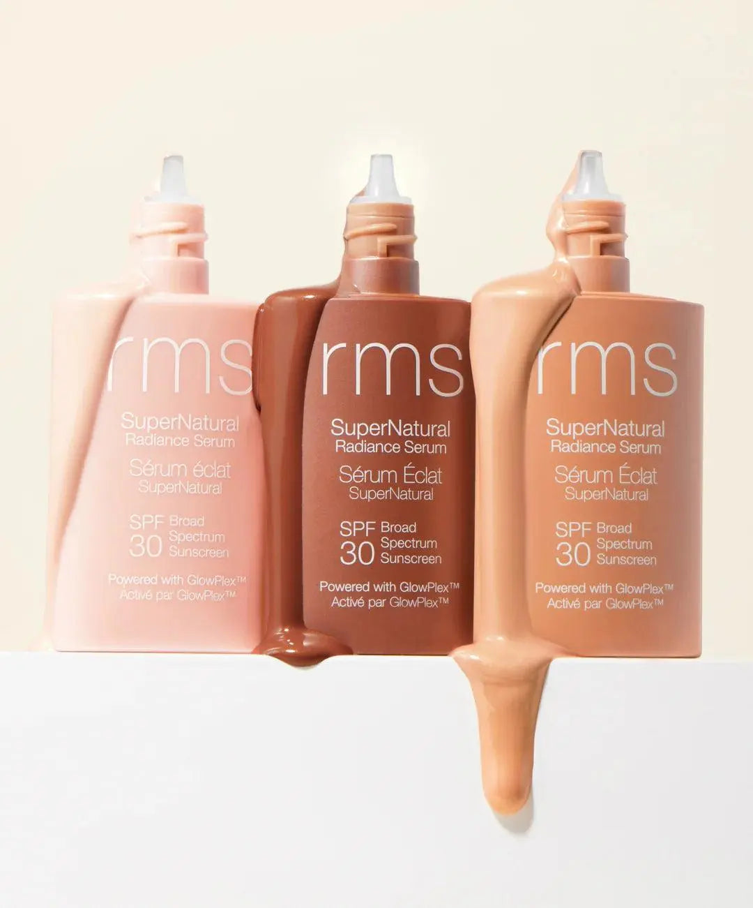 RMS Beauty SuperNatural Radiance Serum SPF 30 in a sleek glass bottle, showing the skincare product with a pump dispenser.