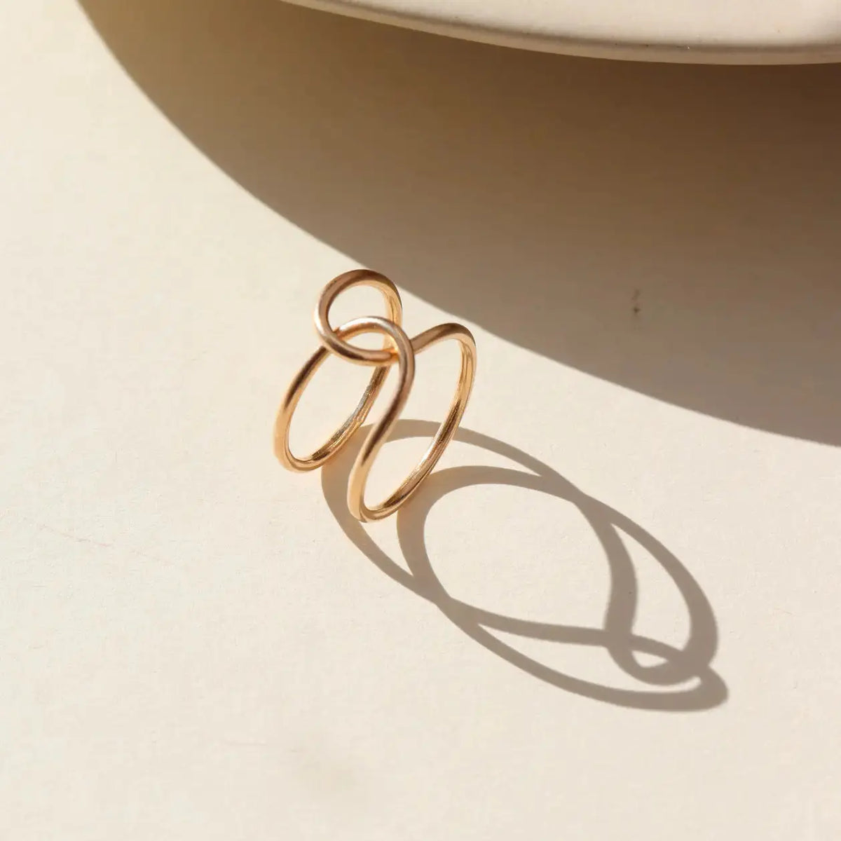 Token Jewelry buckle ring featuring a sleek, polished band with a modern design, ideal for stylish jewelry collection.