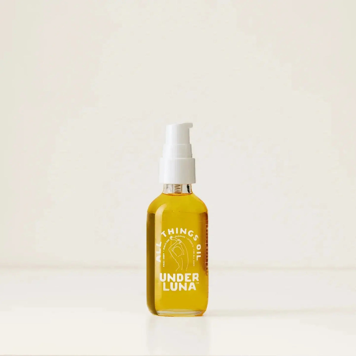 Under Luna All Things Oil body oil bottle with a pump dispenser, natural skincare product for moisturizing and nourishing skin.