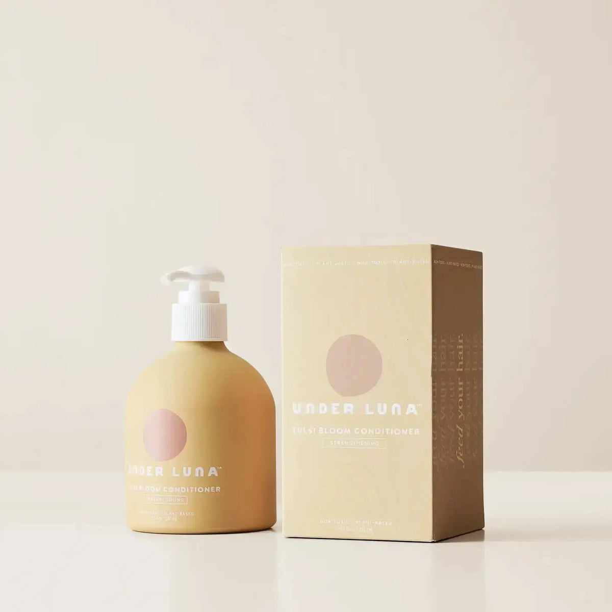 Under Luna Tulsi Bloom Conditioner bottle, 2 oz, with botanical ingredients, showcasing natural plant-based hair care product.