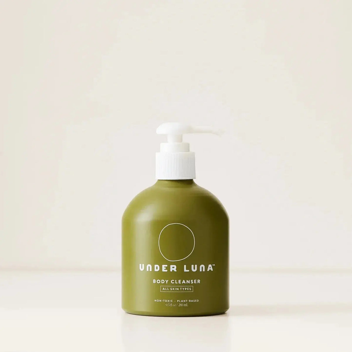 Under Luna Body Cleanser bottle with a sleek design, displayed on a plain background, showcasing its packaging and branding.