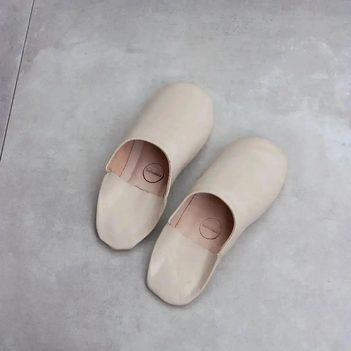 Solid Moroccan leather slippers by Bohemia Design, featuring chalk-colored, handmade slip-on slippers with intricate leather details.