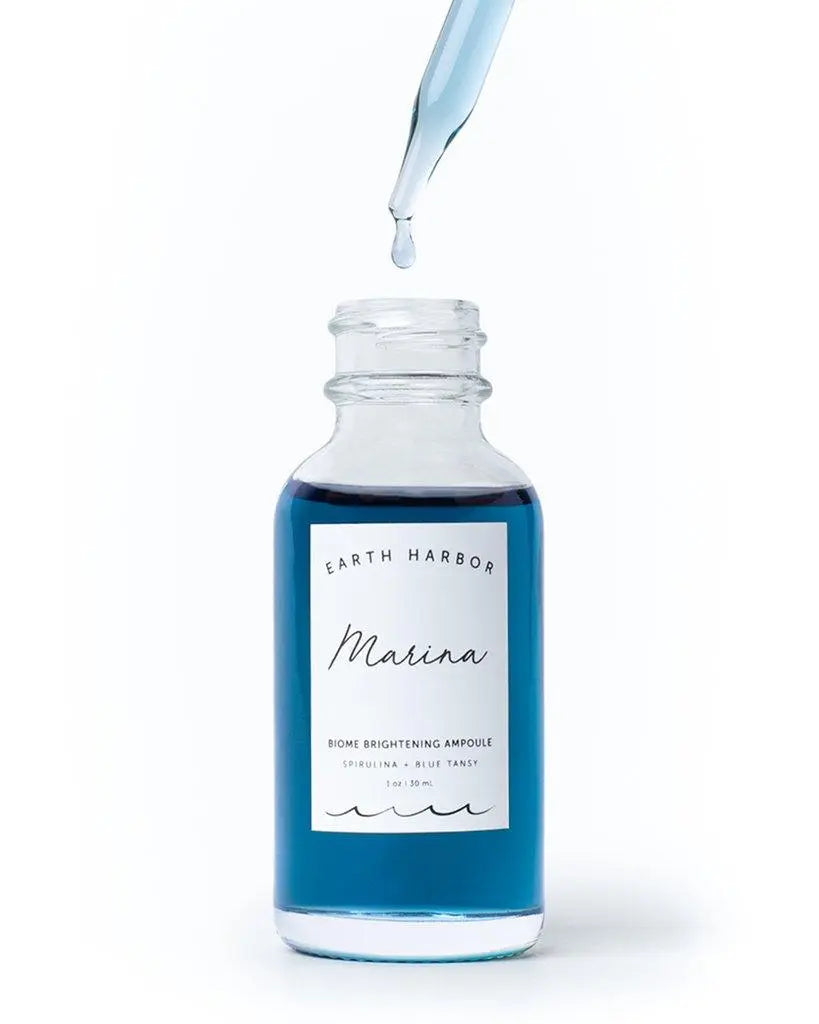 Earth Harbor Marina Biome Brightening Concentrate skincare bottle with dropper in a sleek design, emphasizing natural skincare.