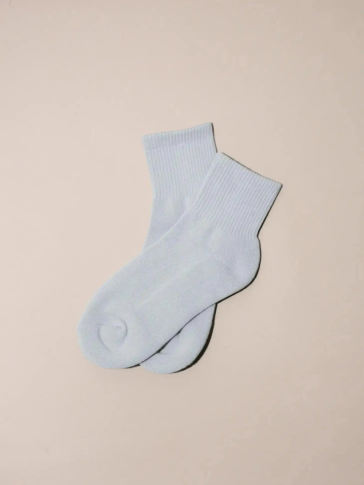 Nat + Noor ankle socks in bone color, featuring a soft knit fabric and subtle branding detail.