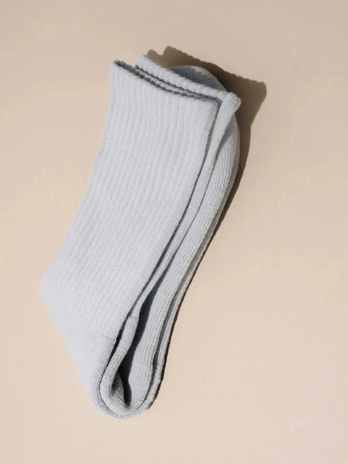 Bone-colored ankle socks by Nat + Noor featuring a soft, comfortable knit fabric and a simple, stylish design.