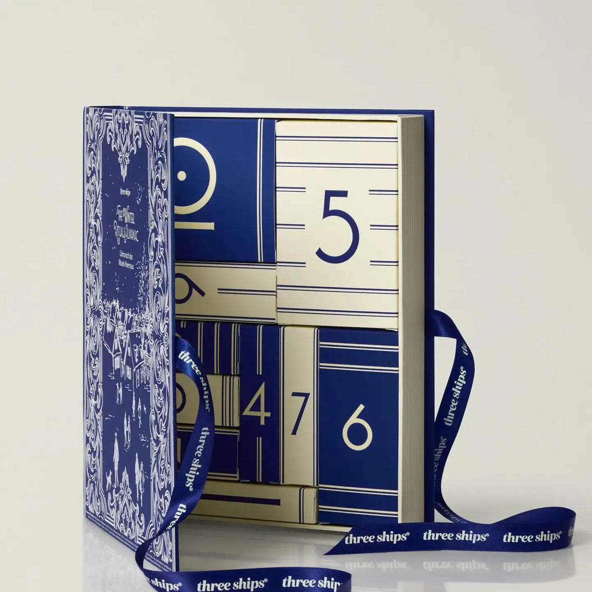 Three Ships skincare advent calendar with numbered doors and festive design, featuring a variety of skincare products.