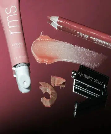 RMS Beauty Line & Shine Kit with natural makeup products, including highlighting and finishing essentials in sleek packaging.