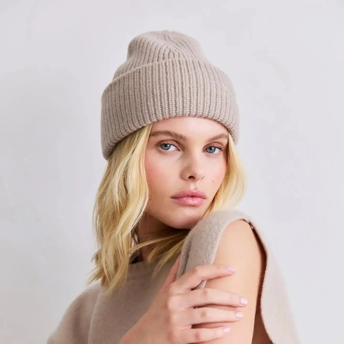 Arctic Fox Cashmere Beanie in soft, warm knit fabric, styled on a model showcasing its cozy, versatile winter apparel.