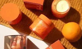 Darlin Skincare Sugared Citrus Body Balm with a creamy texture and citrus scent, displayed in a jar on a neutral background.