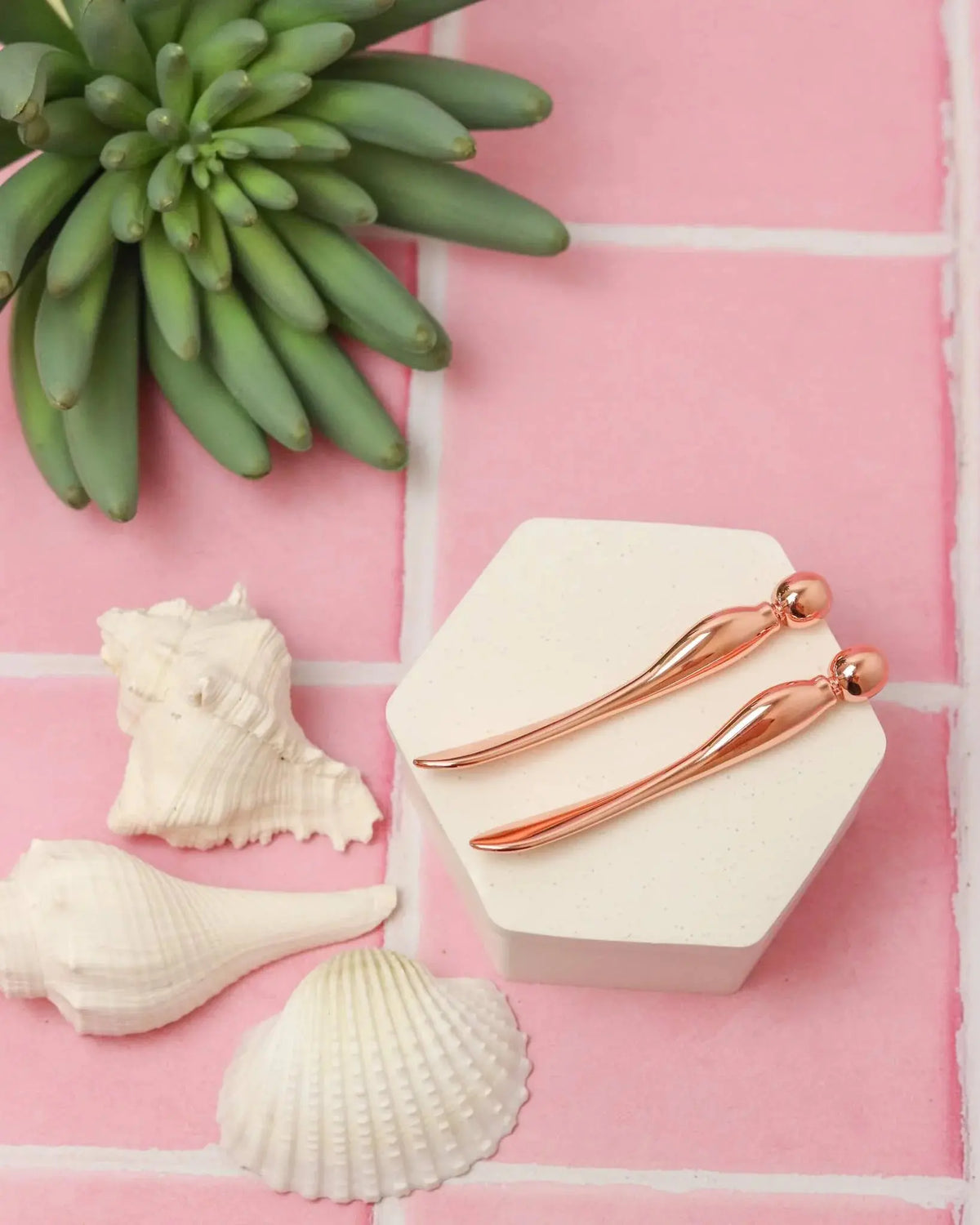 Rose gold applicator and acupressure multi-tool by Earth Harbor with sleek design for facial massage and skincare.