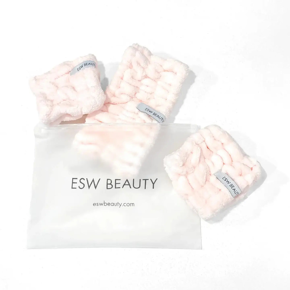 ESW Beauty skincare headband and wristband set shown in a close-up, soft fabric with pink and white design for skincare routines.
