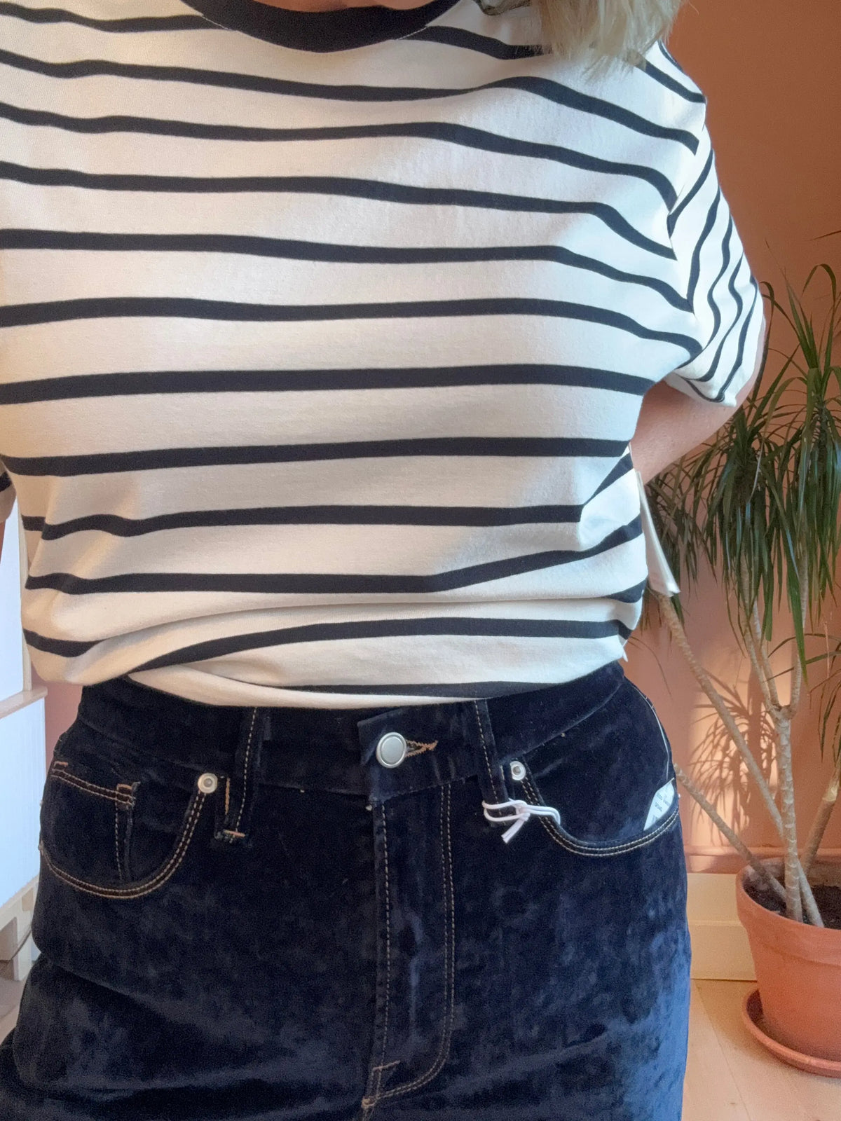 Good American Velvet Denim Jeans, stylish apparel with a fitted silhouette and velvet finish, showcased on a model.