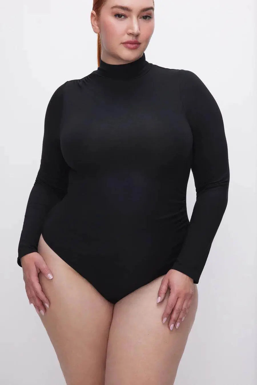 Good American Jane Bodysuit in extra small, close-up of sleek, fitted black tops showcasing the stylish neckline and fabric texture.