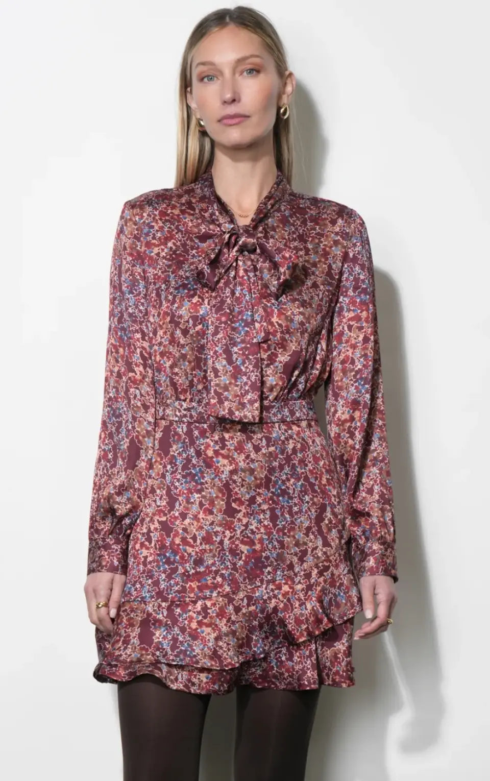 Greylin Olivia tie-neck mini dress in a stylish design, displayed on a hanger with a focus on the dress's neckline and fabric details.