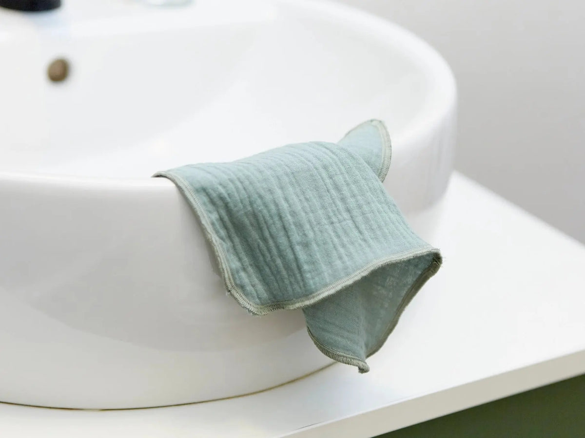 Green HoneyCo muslin reusable face cloths shown, soft and breathable fabric for eco-friendly skincare and gentle cleansing.