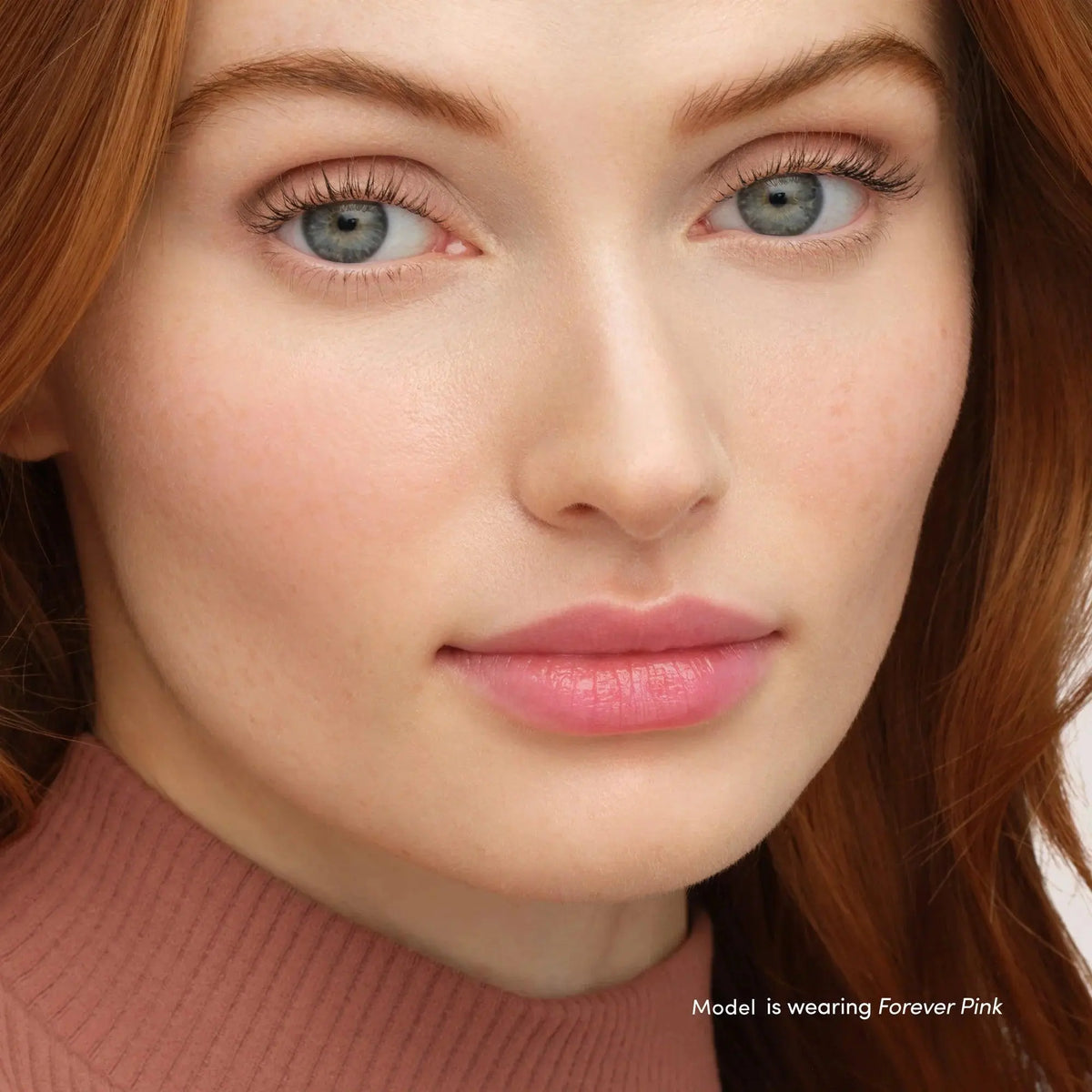 Jane Iredale Just Kissed Lip and Cheek Stain in Forever Pink, a natural-looking lip balm and cheek tint with a soft pink hue.