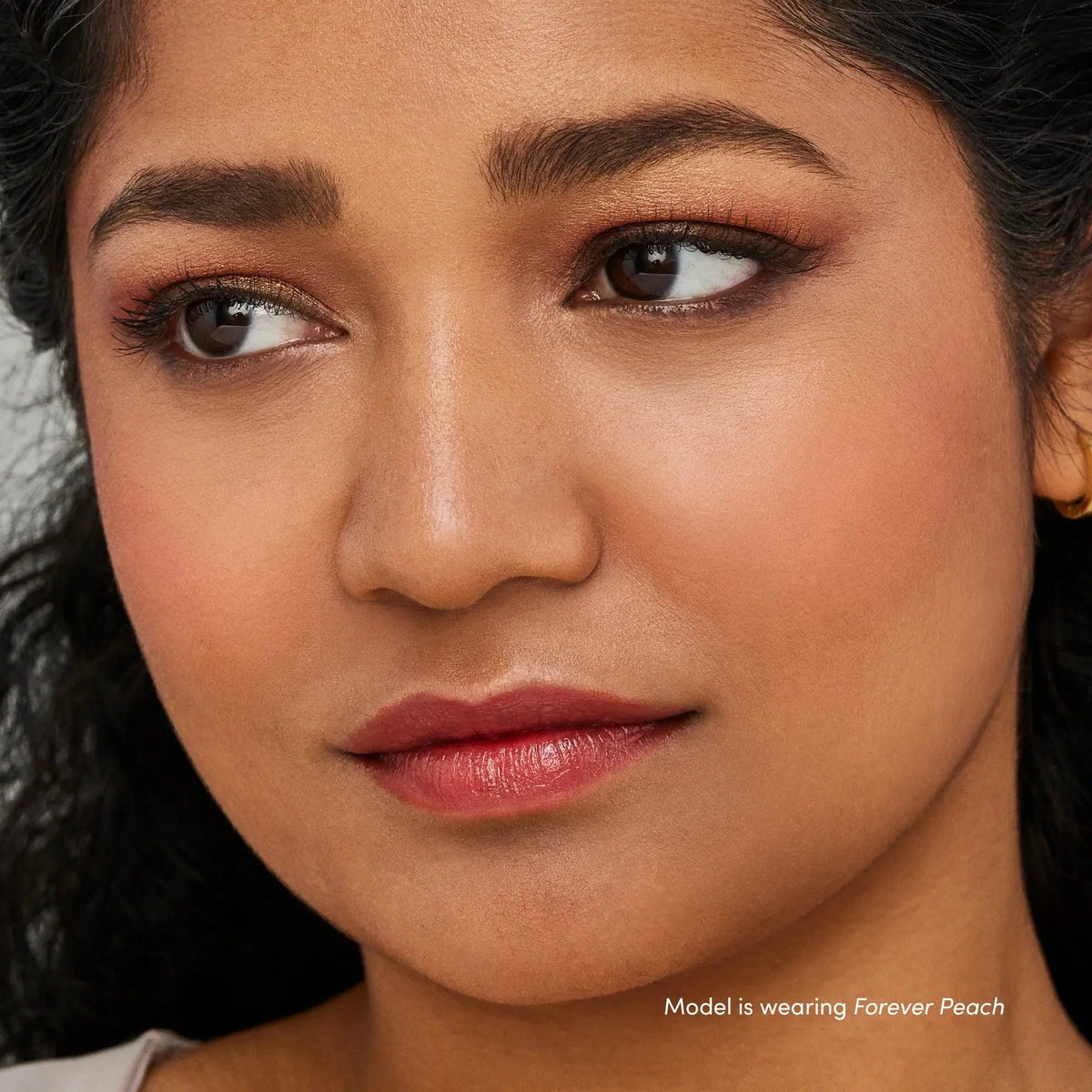 Jane Iredale Just Kissed Lip and Cheek Stain in Forever Pink, a lip balm with a natural pink tint and smooth application.