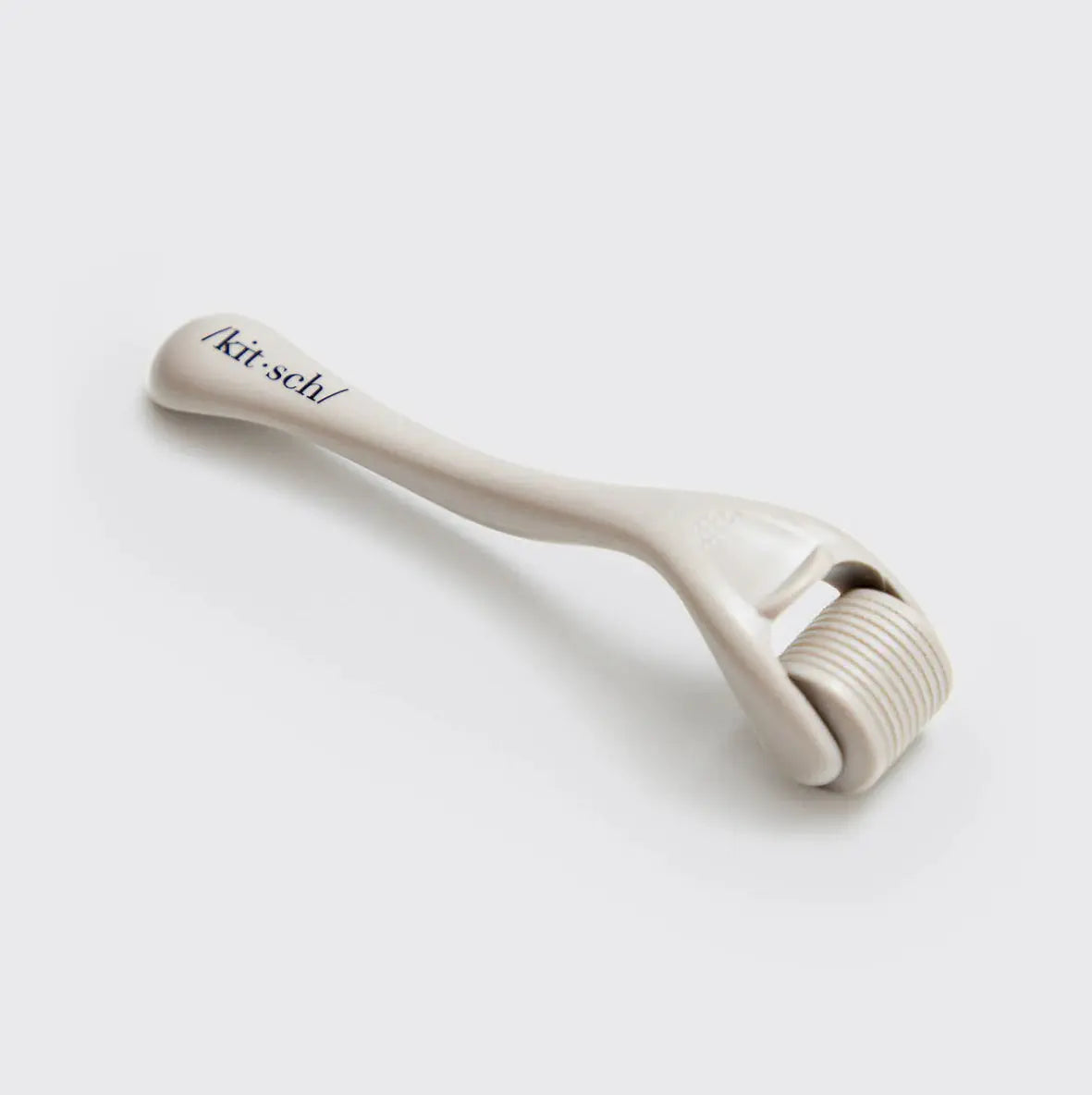 Kitsch Microderma Roller with fine titanium micro-needles for facial skin rejuvenation and exfoliation.