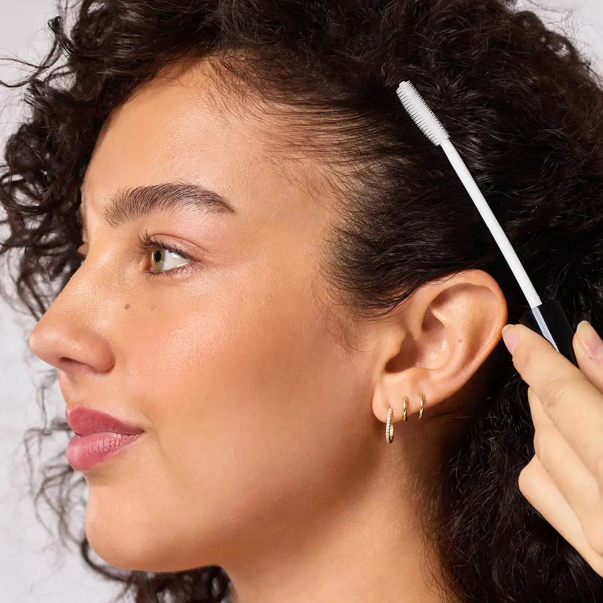 Kitsch Styling Taming Wand hair care tool for smoothing and taming hair, with a sleek black handle and ceramic barrel.