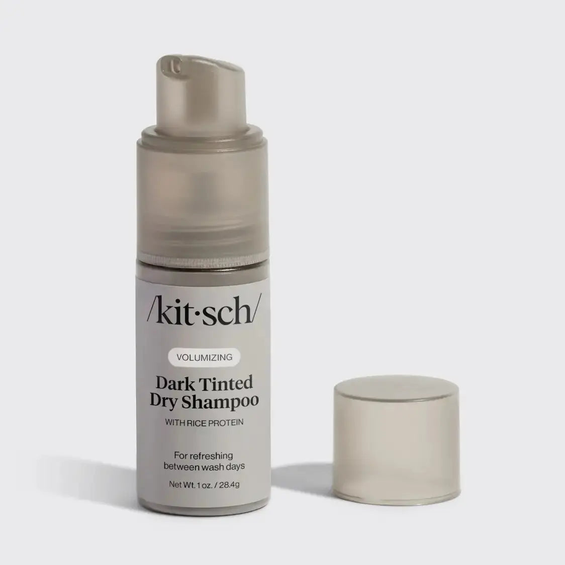 Kitsch brown tinted dry shampoo for hair, showing the product bottle with brown tint and spray nozzle, on a white background.