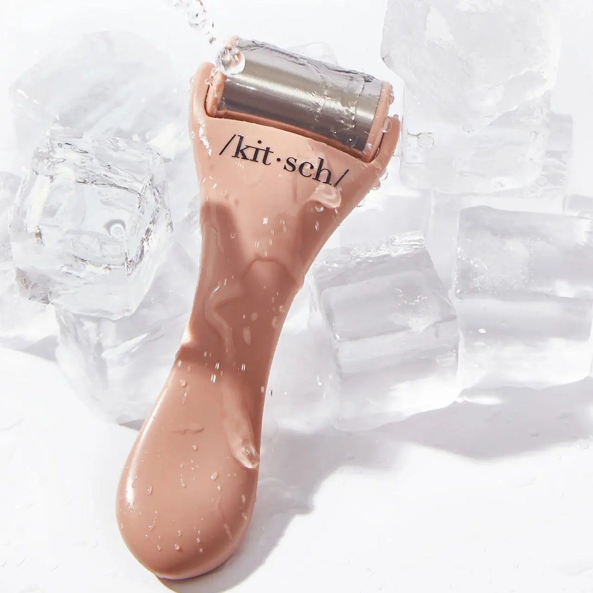 Kitsch Cool Down Ice Roller for skincare, featuring a clear handle and metal roller ball for soothing facial cooling therapy.