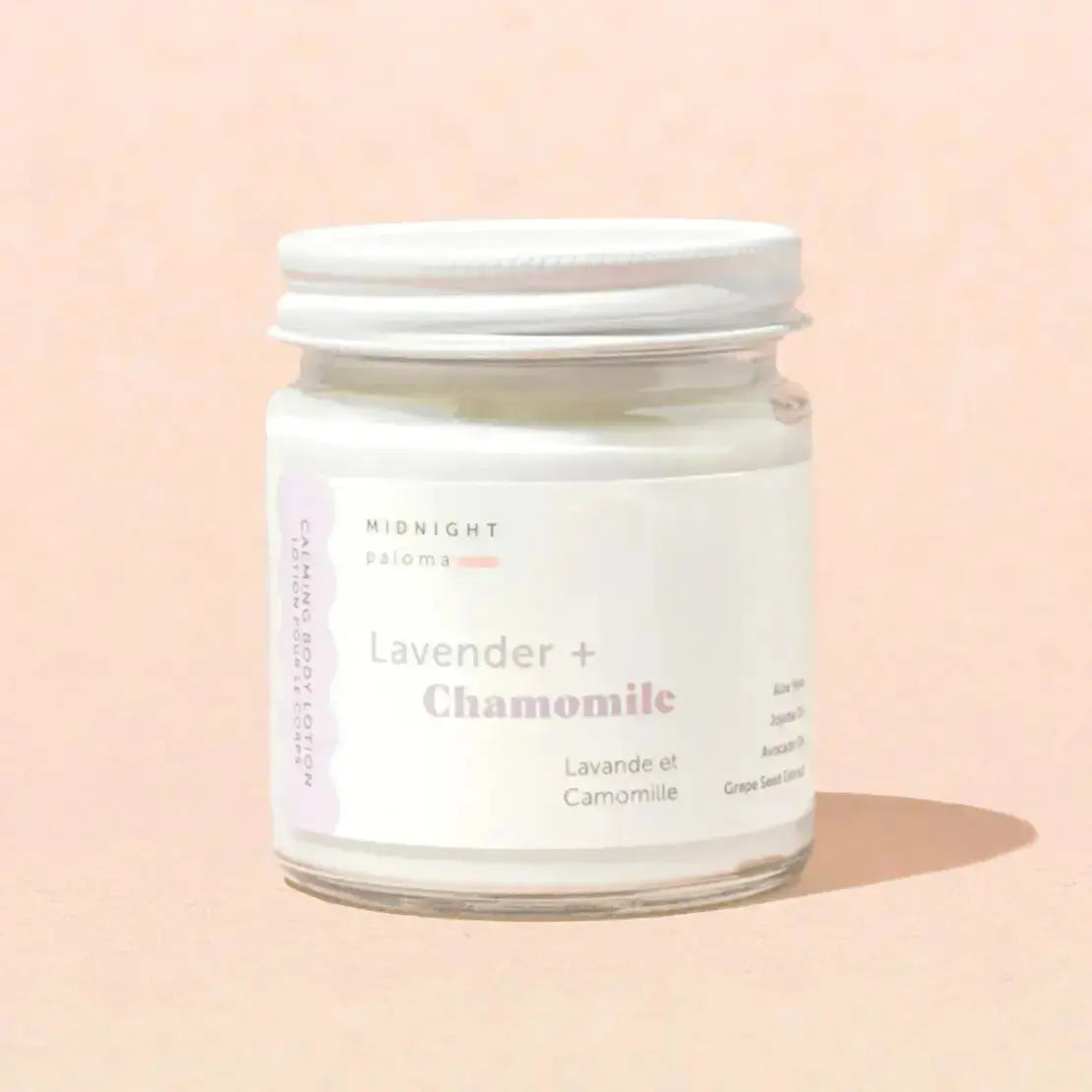 Chamomile and lavender body lotion by Midnight Paloma, creamy texture with floral scent, in a white pump bottle.