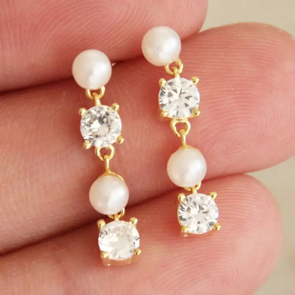 Gold-plated Ruth earrings by naive featuring sparkling cubic zirconia stones, elegant jewelry for special occasions.