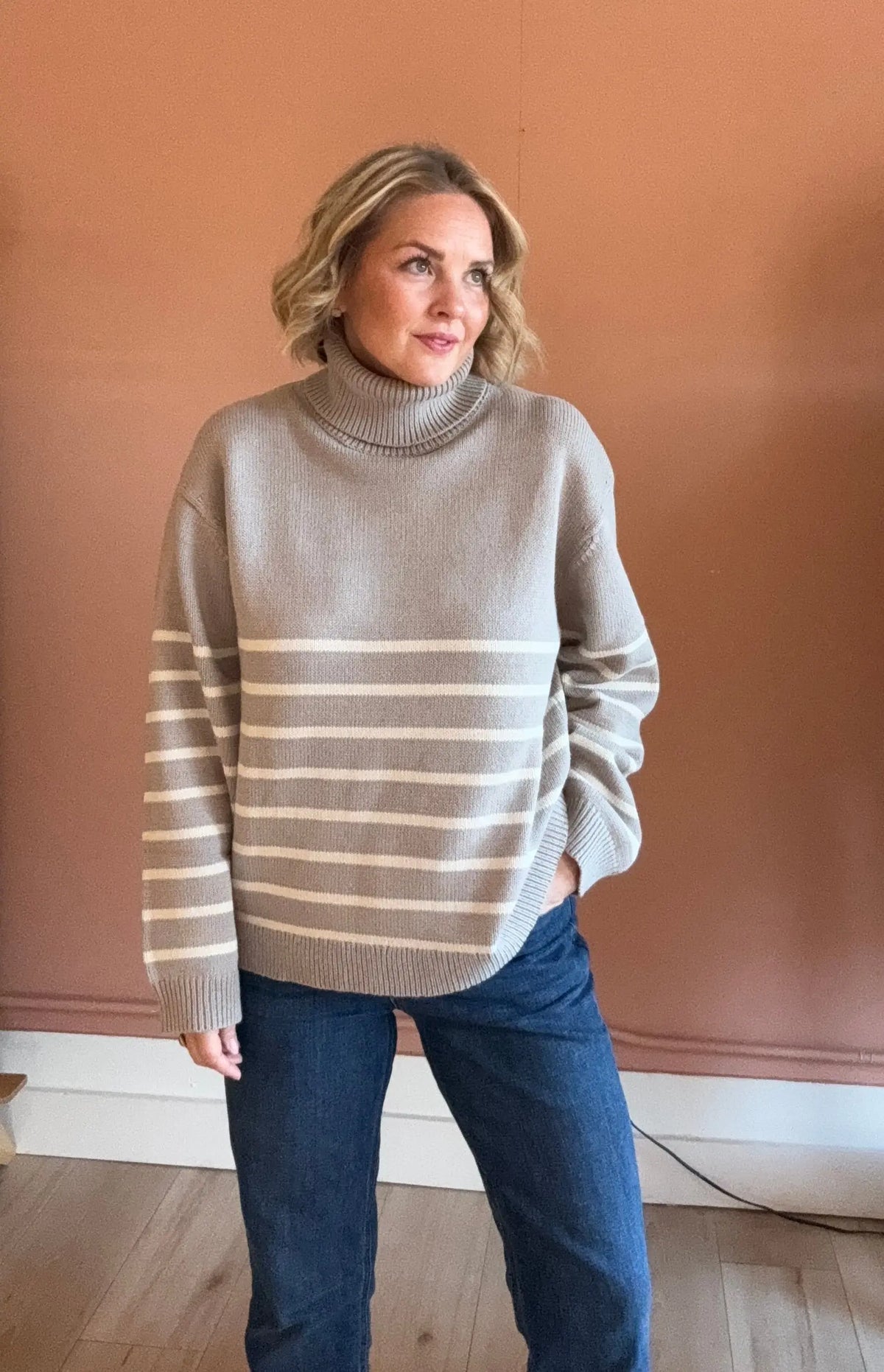 Nude Lucy Venus turtleneck sweater in extra small, soft knit fabric, featuring a fitted silhouette and classic turtleneck design.