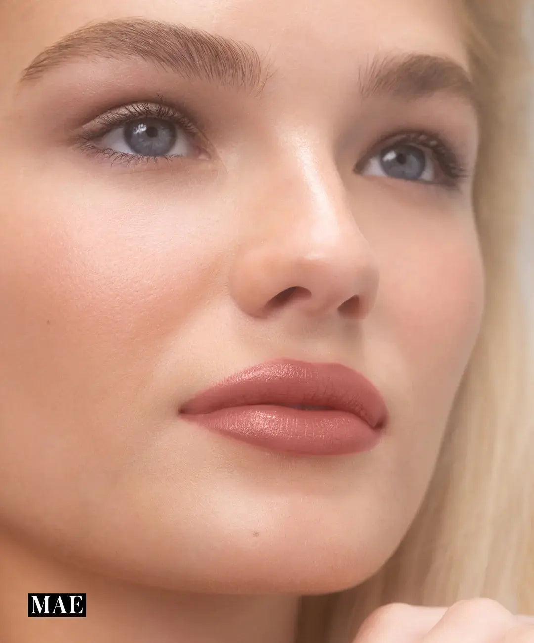 RMS Beauty Legendary Serum Lipstick in Nudes, showcasing a natural nude lipstick shade on a model for a beauty product image