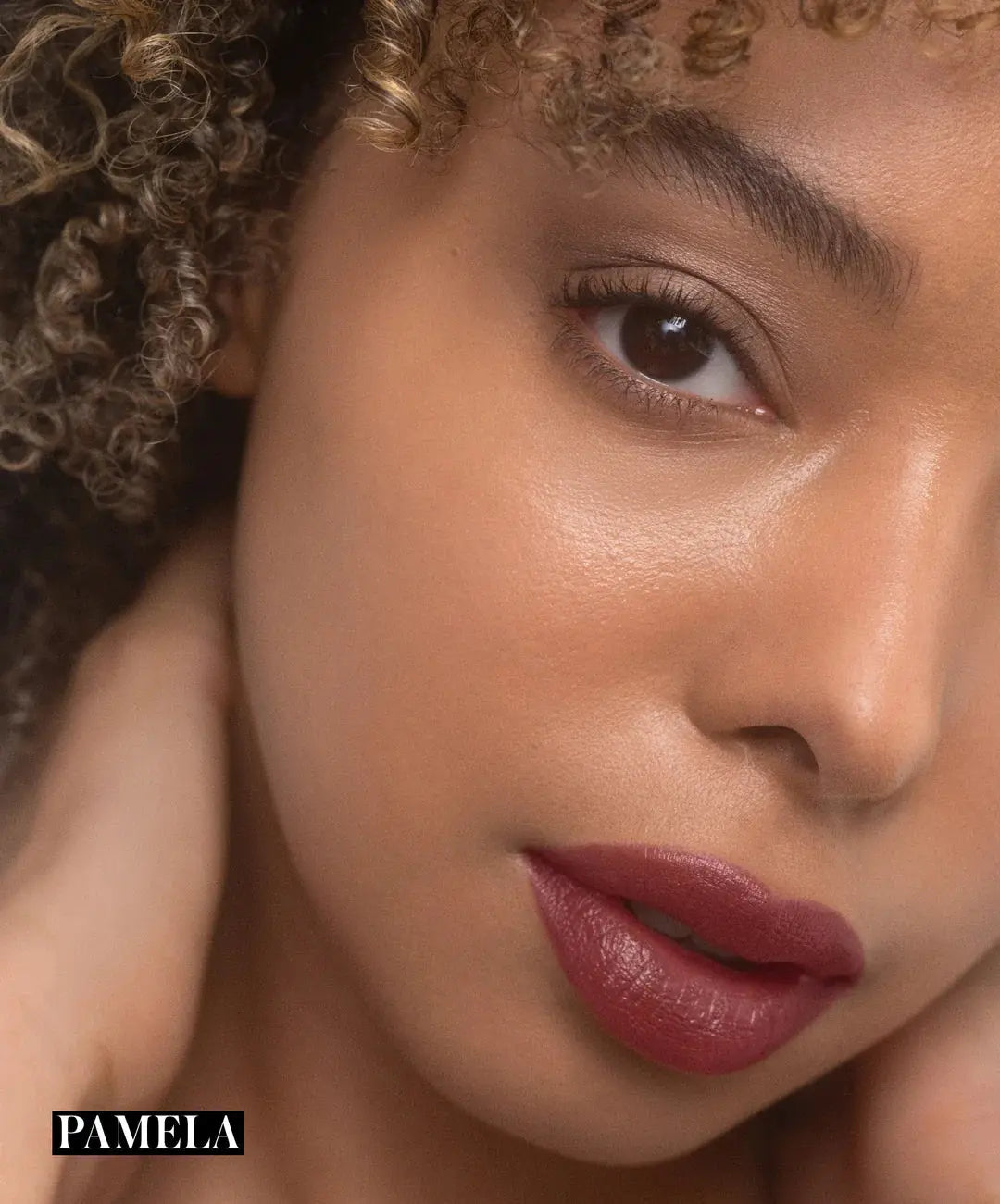 RMS Beauty Legendary Serum Lipstick in Nudes, sleek lipstick tube, model holding the nude shade, close-up of the product against a neutral background.