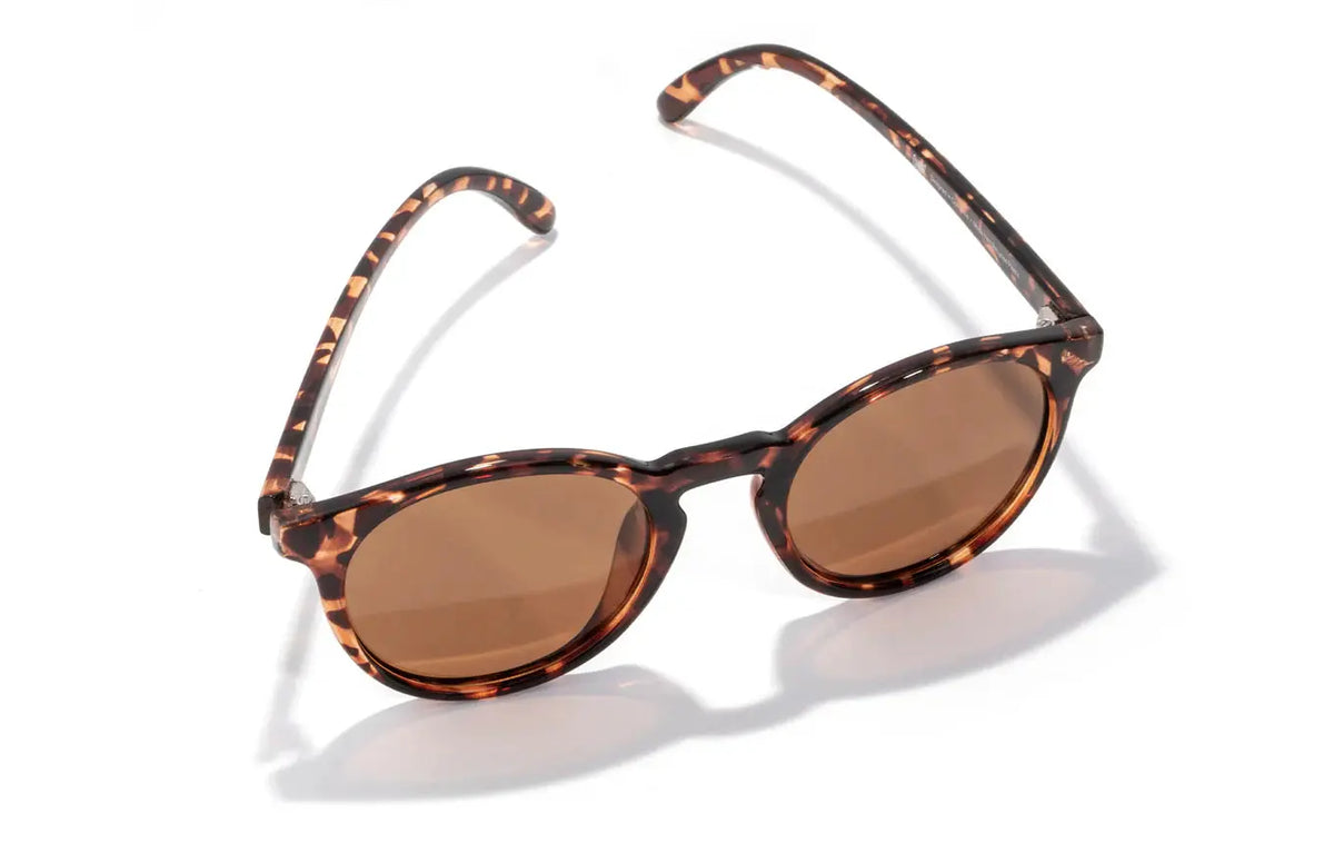 Sunski Dipsea Tortoise Amber sunglasses with rounded frames and amber-tinted lenses on a neutral background