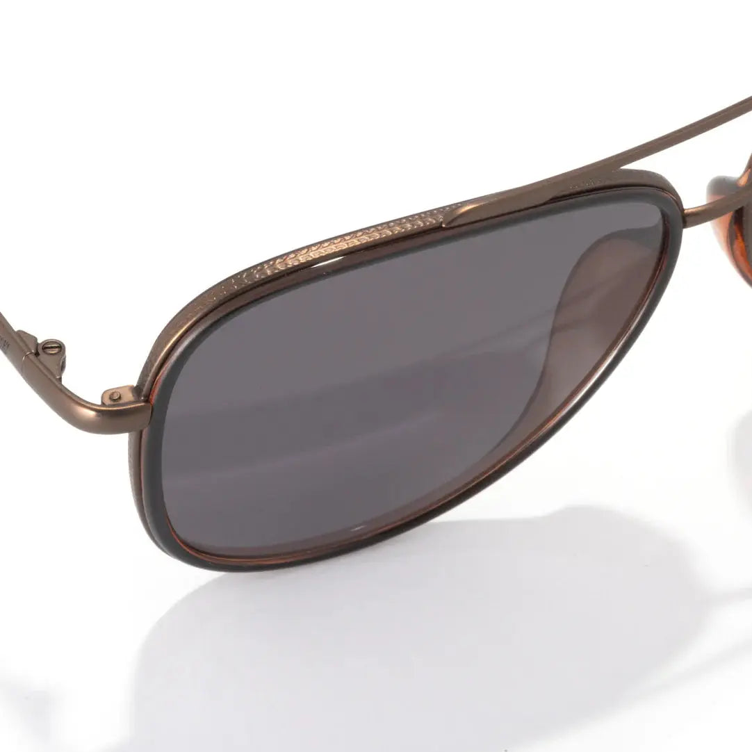 Sunski Sirocco polarized aviator sunglasses with metal frames and tinted lenses, resting on a white background.