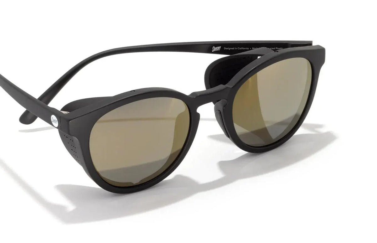 Sunski Tera black and gold sunglasses with rounded frames and tinted lenses, stylish and modern eyewear.