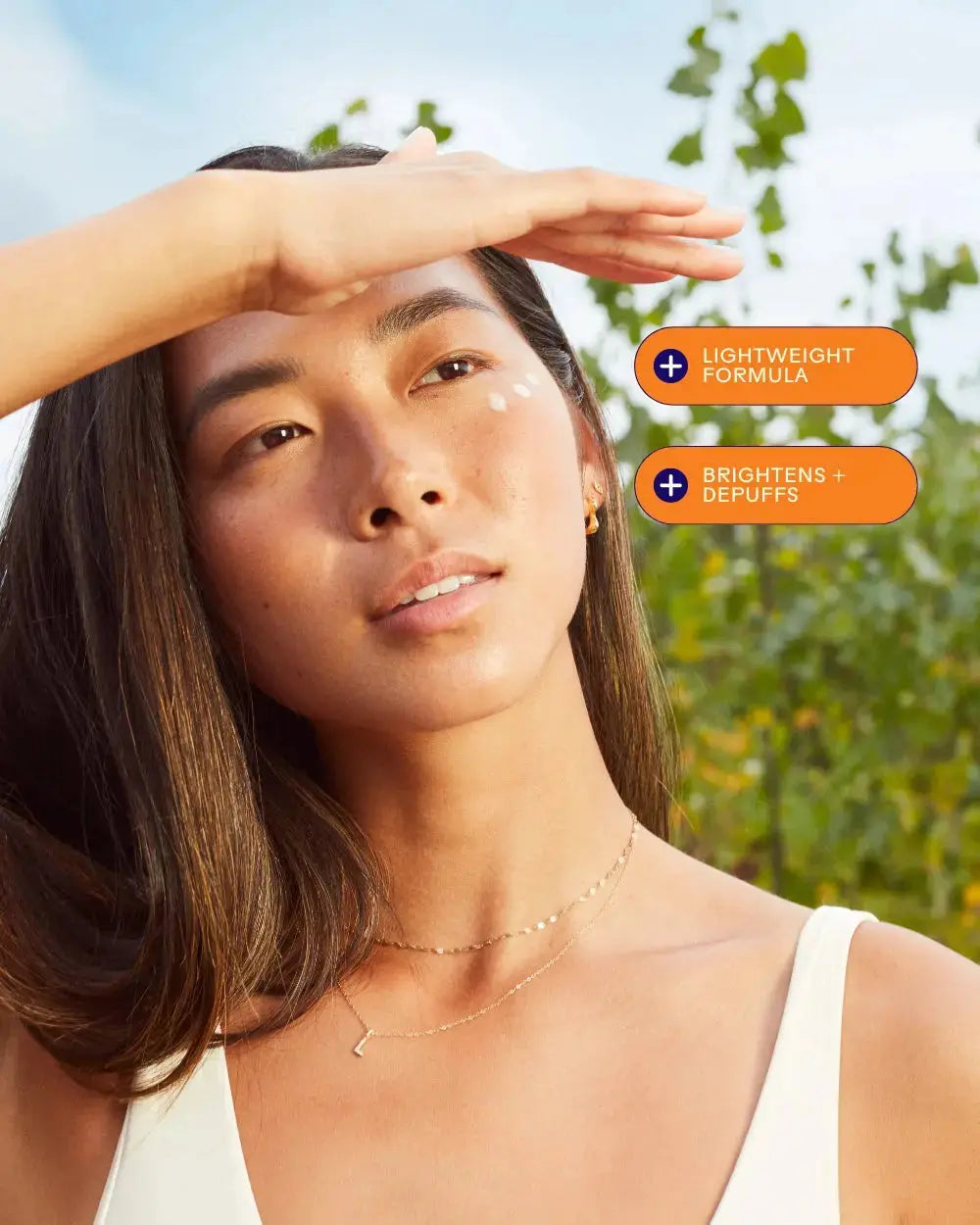 First Light Vitamin C and caffeine eye cream by Three Ships, shown in a sleek tube with a white and orange design.