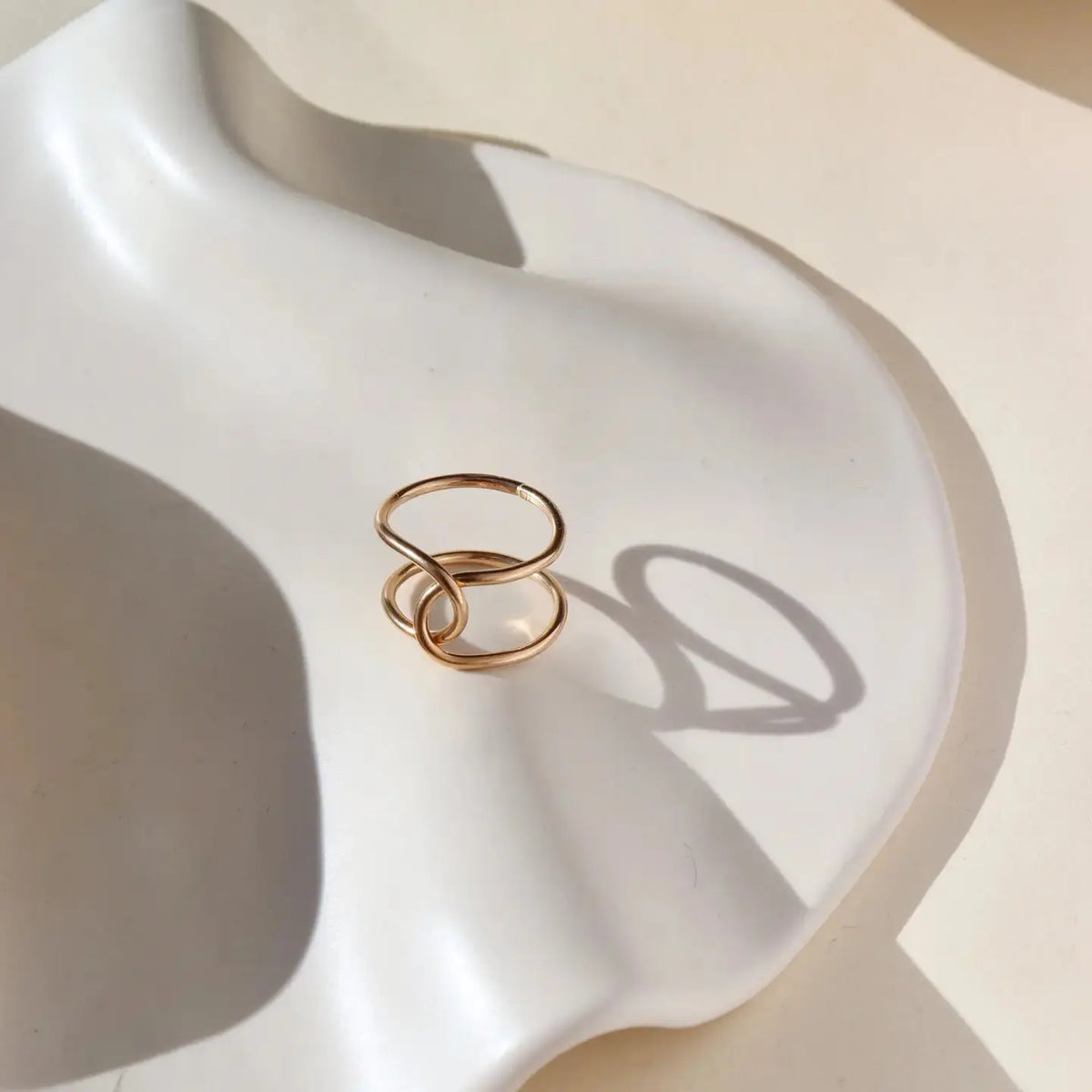Elegant Token Jewelry buckle ring featuring a sleek design with a polished metal finish, perfect for stylish jewelry collection.